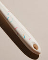 Close up of the handle of the GIR Sprinkle Flip on a cream background. 