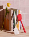 The GIR 3 Piece Mini Tool Set Red Ultimate Flip resting upright on books next to the GIR Ultimate Flip in Sprinkles.