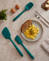 A top shot of the GIR Emerald 3 piece tool set on a marble surface with a plate of scramble eggs and toast in the middle. 