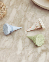 Close up of GIR Bottle Stoppers in Celebration on a marble background. 