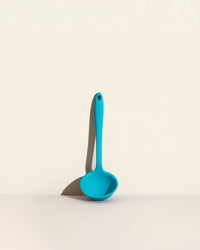GIR Ultimate Ladle in Teal on a cream background.
