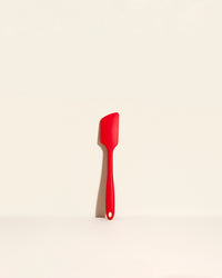  GIR Spatula in Red on a cream background.