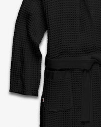 A close-up on the Onsen Bath Robe on a white background outlining the sleeve and pocket.