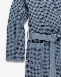 A close-up view of the Onsen Bath Robe on a white background outlining the sleeve and pocket,