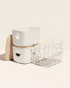 Two Open Spaces Cream Medium Storage Bins with wooden lids and Two Cream Medium Storage baskets on a cream background.
