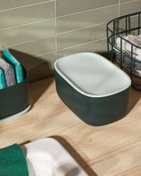 Top view of the  Dark Green Small Storage Bin with Mint Lid on a wooden surface. 
