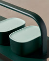 Close up view of two Dark Green Small Storage Bin with Mint Lid on a dark green surface.