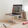 The Open Spaces Shelf Riser with a lap top on it in a workstation. 