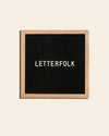 Letterfolk Poet Letter Board in Oak on a cream background.