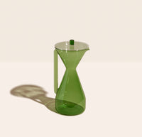 The Verde Pour Over Carafe on a cream background. 