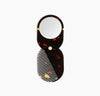 The Poketo 2 in 1 Pocket Comb Mirror in Black Amber on a white background. 