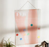 The Acrylic Poster Hanger in Large holding up a wall planner. 