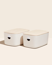Two Open Spaces Large Cream Storage Bins with lids on a cream background. 