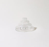 The Clear Glass Meso Incense Holder on a grayish background.