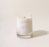 A 8 Oz Aviles candle on a cream background. 
