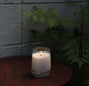 A 8 oz Candle on a grayish background. 
