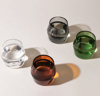 A Top view of the Amber, Clear, Gray and Verde Century Glasses on a cream background.