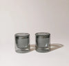 Two 6 oz Gray Double Wall Glasses on a cream background. 