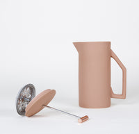 The Matte Sand Ceramic French Press, mesh steel Filter, stem and lid on a grayish background. 