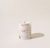 A 2.5 Oz Castillo candle on a cream background. 